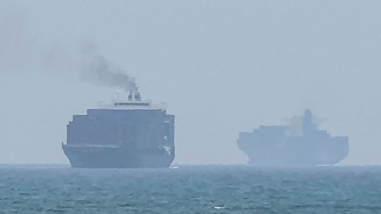 This frame grab taken from AFPTV video footage on July 12, 2026 shows cargo ships anchoring near the Strait of Hormuz; illustrative