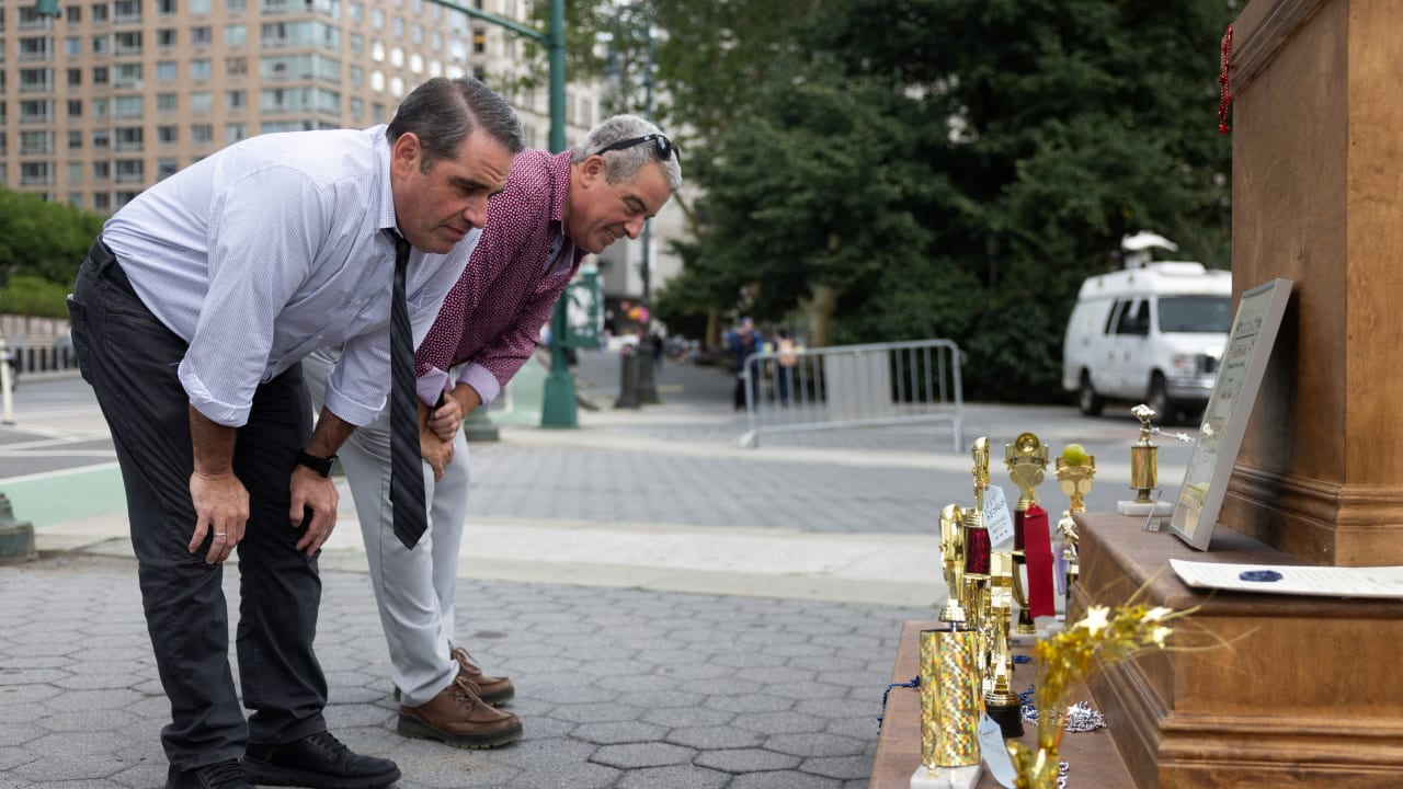 People look at an "Iran war participation trophy" installation, placed by the protest group The Secret Handshake, in New York City, US, July 29, 2026. 