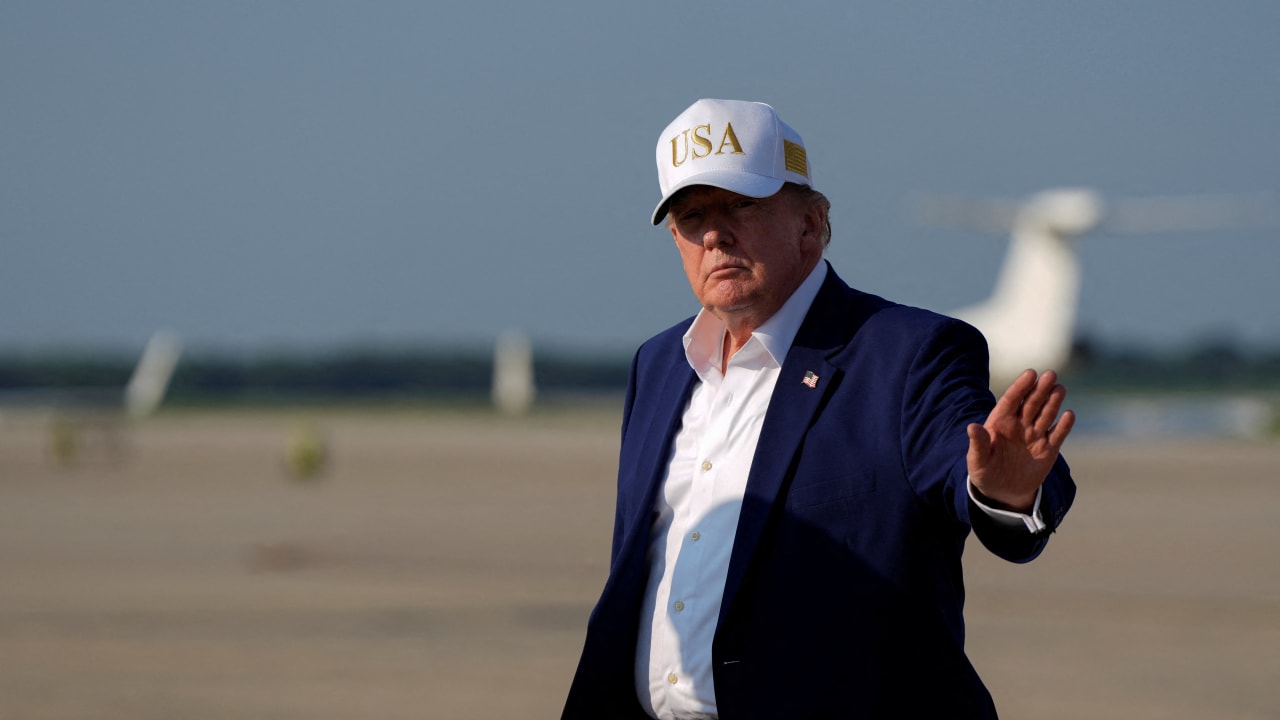 U.S. President Donald Trump waves as he disembarks Air Force One at Joint Base Andrews, Maryland, US, August 9, 2026.