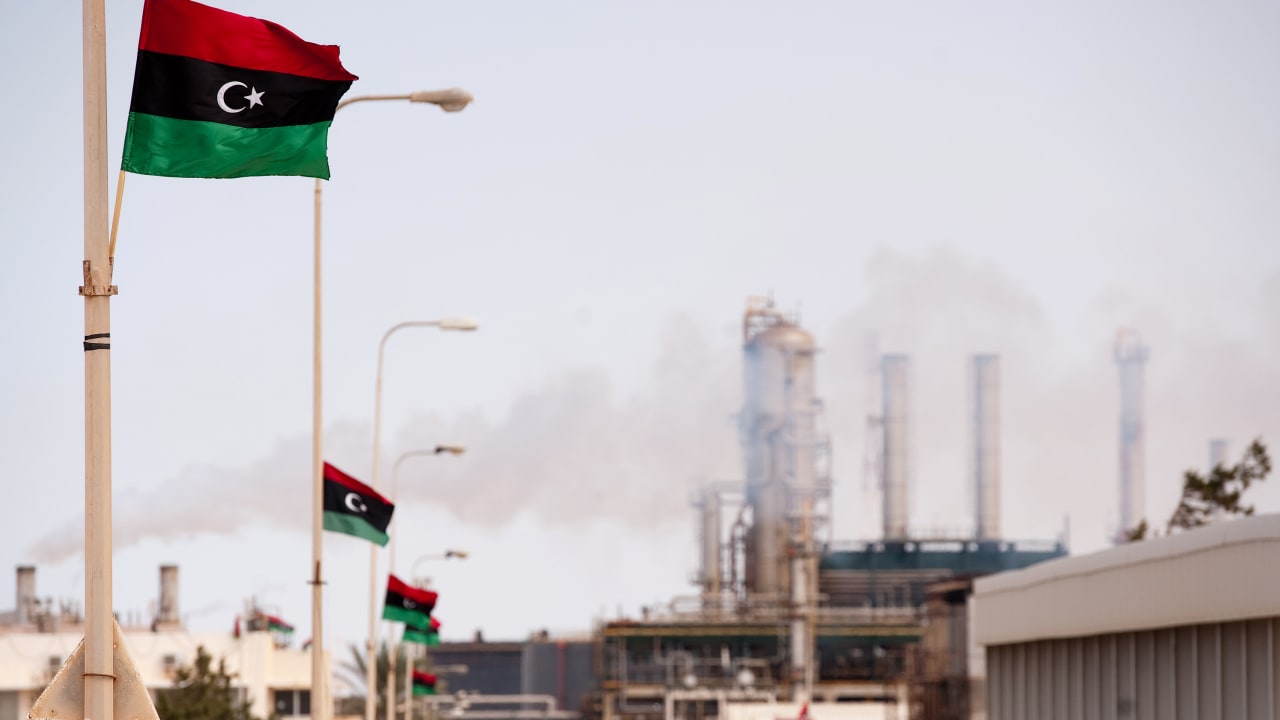 The new Libyan flag flutters outside an oil refinery in Zawiya on September 23, 2011. 