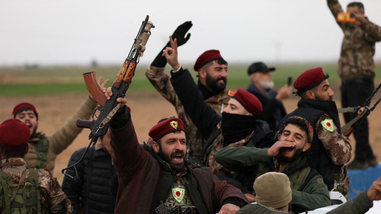 Members of Syrian Democratic Forces react after withdrawing from the front lines on the outskirts of the town of Tel Hamis following the agreement between the SDF and the Damascus government, which stipulates the withdrawal of the Syrian army and the SDF, in Qamishli, Syria, February 13, 2026. 