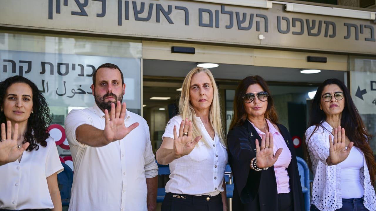 Friends and colleagues of attorney Arbel Feldman stand in his memory outside a remand hearing for suspected killer Ahmad al-Rajoub at the Rishon Lezion Magistrate's Court earlier this month.