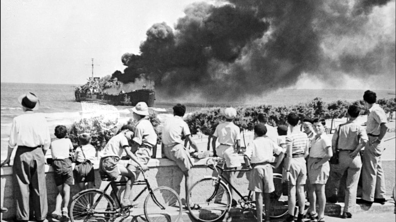 THE ‘ALTALENA’ burns off Tel Aviv in June 1948. Its wreckage may lie beneath the Mediterranean, but the political battle over what happened aboard it has never been buried. 