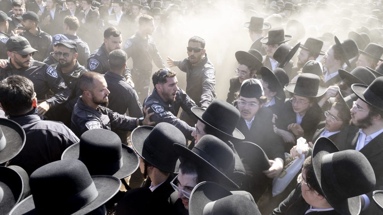 Israeli police clash with haredi protesters during a mass demonstration against military conscription outside the Beit Lid military base in June. 