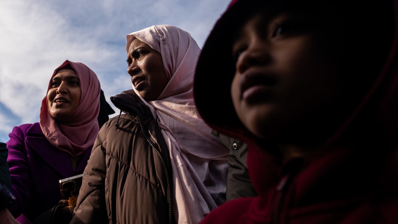 Woman and children receive traditional sweets as they attend Eid al-Fitr prayers at Brooklyn's Prospect Park on March 20, 2026, in New York City.