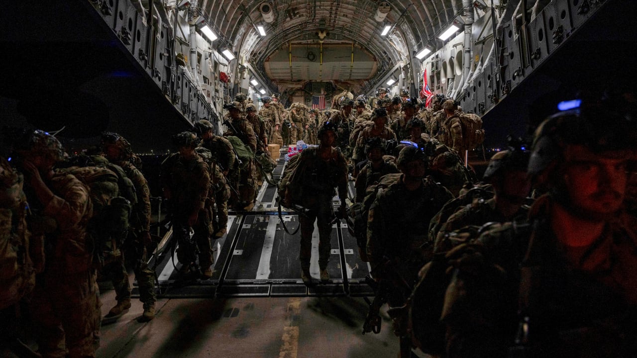 US Soldiers, assigned to the 82nd Airborne Division, deplane a U.S. Air Force C-17 Globemaster III aircraft after touching down at Ali Al Salem Air Base, Kuwait.