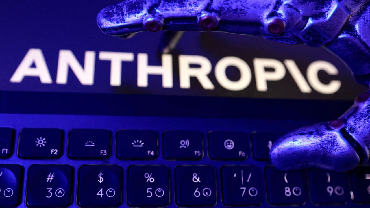 Anthropic logo, a keyboard, and a robotic hand in this illustration taken June 5, 2026. 