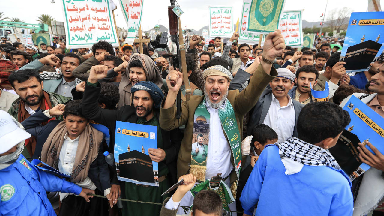 Supporters of the Houthis brandish their weapons during a protest against the Saudi intervention in Yemen and against Saudi Arabia after the Houthis fired at the holy city of Mecca, in Sanaa on September 18, 2026. 