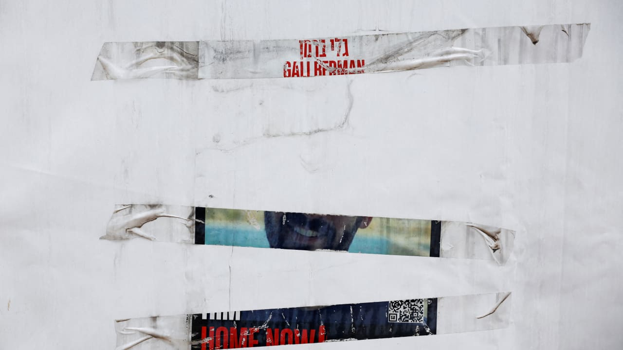 A partially torn poster of a hostage kidnapped in the deadly October 7 attack on Israel by the Palestinian Islamist group Hamas is seen at a public plaza in front of the Tel Aviv Museum of Art.