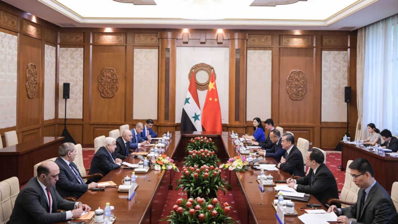 Syrian Foreign Minister Walid Muallem (3rd L) speaks with Chinese Foreign Minister Wang Yi (3rd R) during a meeting at Diaoyutai state guesthouse in Beijing on June 18, 2019. 