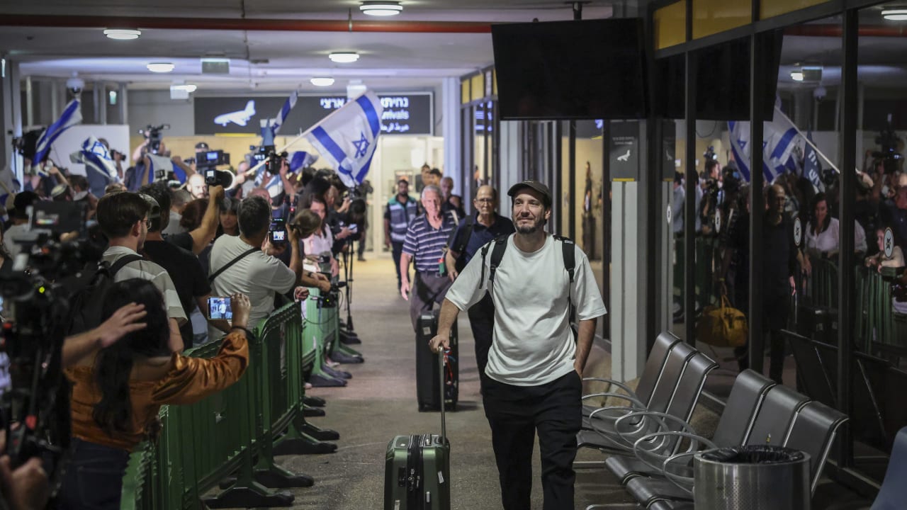 Passengers from Flydubai flight FZ1073 walk with their family members through the arrivals hall at Ben Gurion International Airport near Tel Aviv, after their original flight from Dubai to Israel was diverted to Saudi Arabia following a suspected terror attack, September 30, 2026.