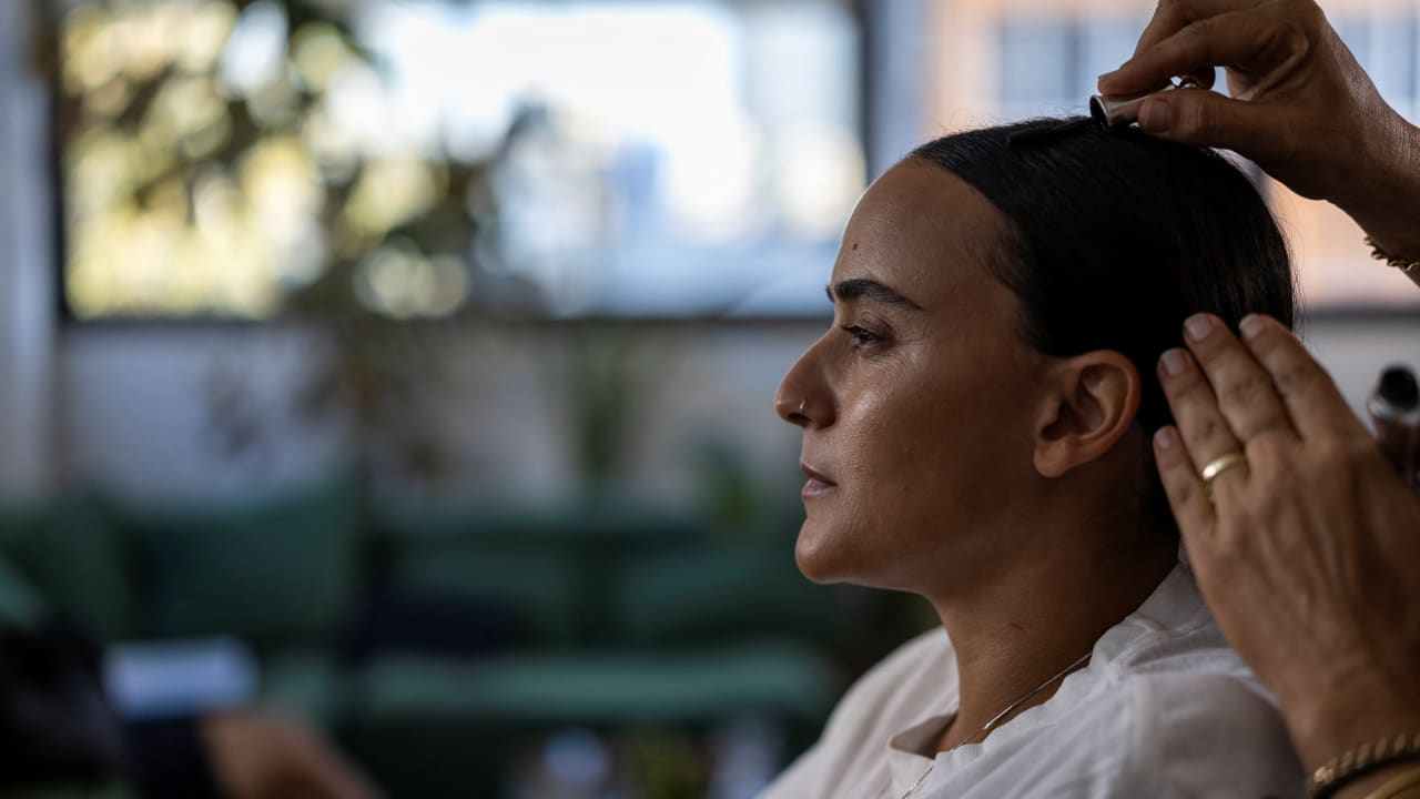 British-Israeli Emily Damari, 30, a former hostage, has her hair done during a photo shoot for her clothing brand which carries the slogan ‘never lose yourself.’