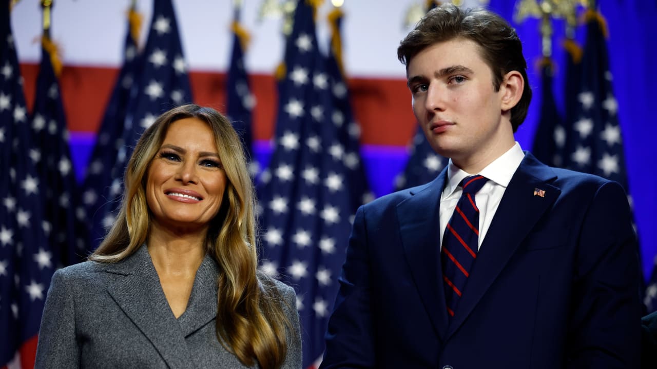 Former first lady Melania Trump and Barron Trump look on as Republican presidential nominee, former U.S. President Donald Trump speaks during an election night event at the Palm Beach Convention Center on November 06, 2024 in West Palm Beach, Florida.