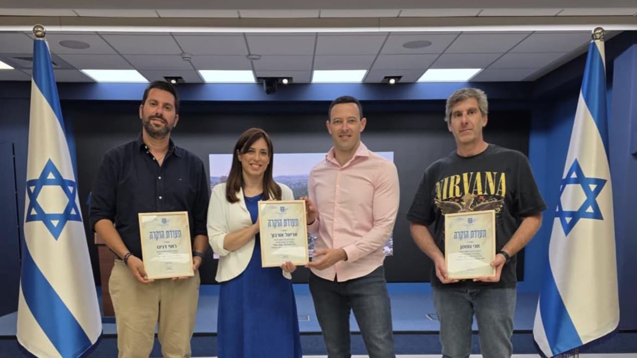 Filmmakers Ariel Orbuch, Roy Danino, and Hagai Gutman, creators of NAZA, The True Story receive ertificates of appreciation from National Public Diplomacy Directorate head Tzipi Hotovely on Thursday, October 8, 2026. 