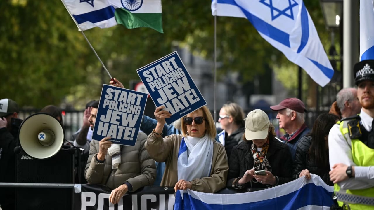 A counter-protest displaying Israeli flags watches as a National March in support of Palestine, organized by Palestine Solidarity Campaign, moves through central London on October 10, 2026
