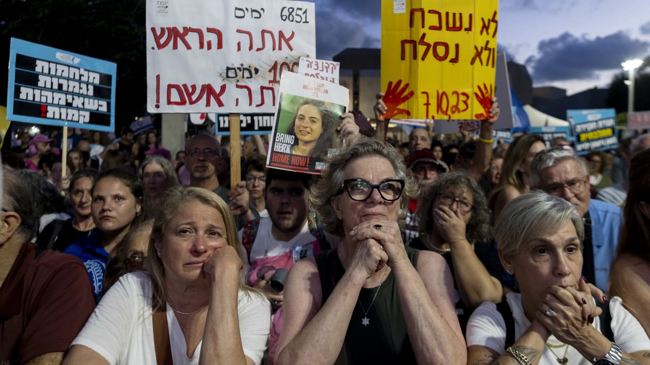 Calls for a state commission of inquiry have continued as Israelis seek an authoritative account of the failures that led to October 7. Families of victims of the October 7 attacks and supporters hold photos and signs during a protest march on July 2, 2026, in Tel Aviv.