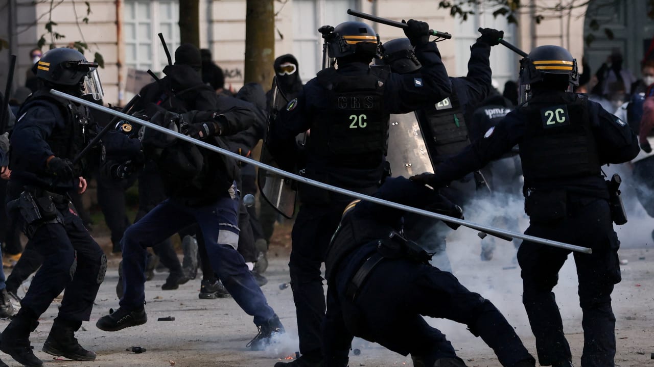 A police officer falls during a demonstration as part of nationwide protests called by the "Yellow Vests" movement against the cost of living and rising fuel prices, in Nantes, France, October 17, 2026.