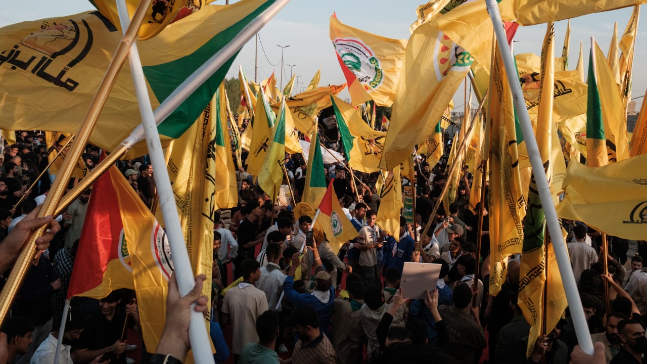 Supporters of the Popular Mobilisation Forces (PMF) chant slogans and wave flags at a rally celebrating the end of the U.S. military presence in Iraq on September 30, 2026 in Baghdad, Iraq. 