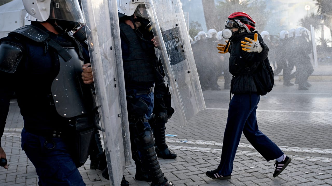 A protester faces off with a police unit during an anti-government demonstration in central Tirana on October 17, 2026, as protests continued for a fifth consecutive day over university conditions and demands for the resignation of Albanian Prime Minister Edi Rama.
