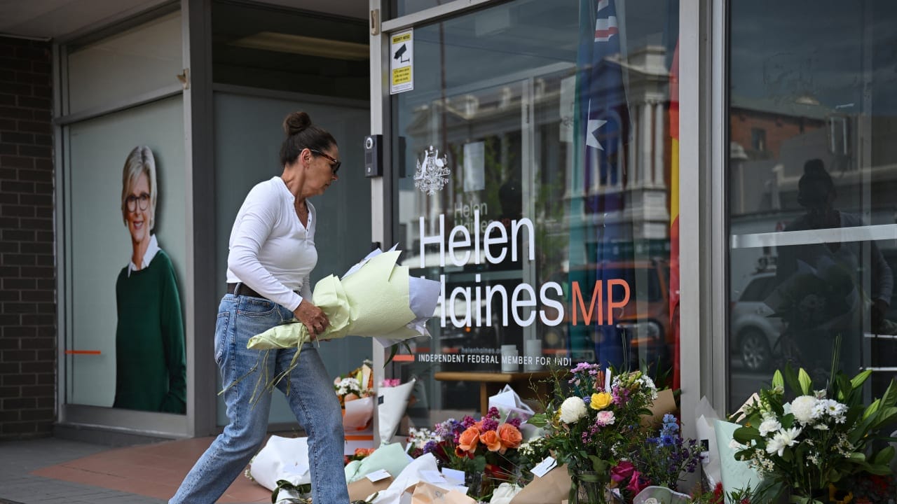 A woman leaves flowers outside the electoral office of independent Australian lawmaker Helen Haines Tuesday, 20th October 2026