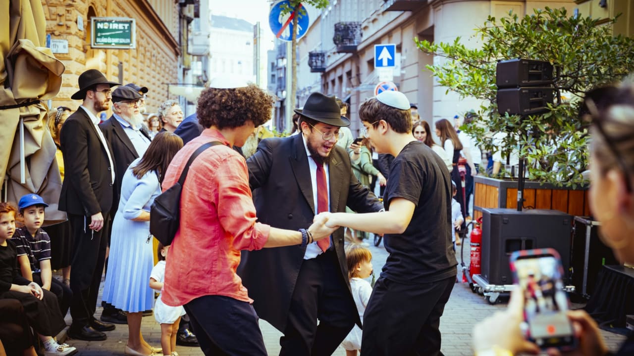 Congregants dance outside the historic Wagon Drivers' Synagogue in Budapest, Hungary, October 22, 2026.