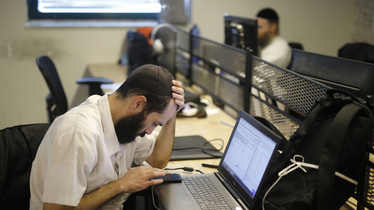 A Jewish man works in an office. 