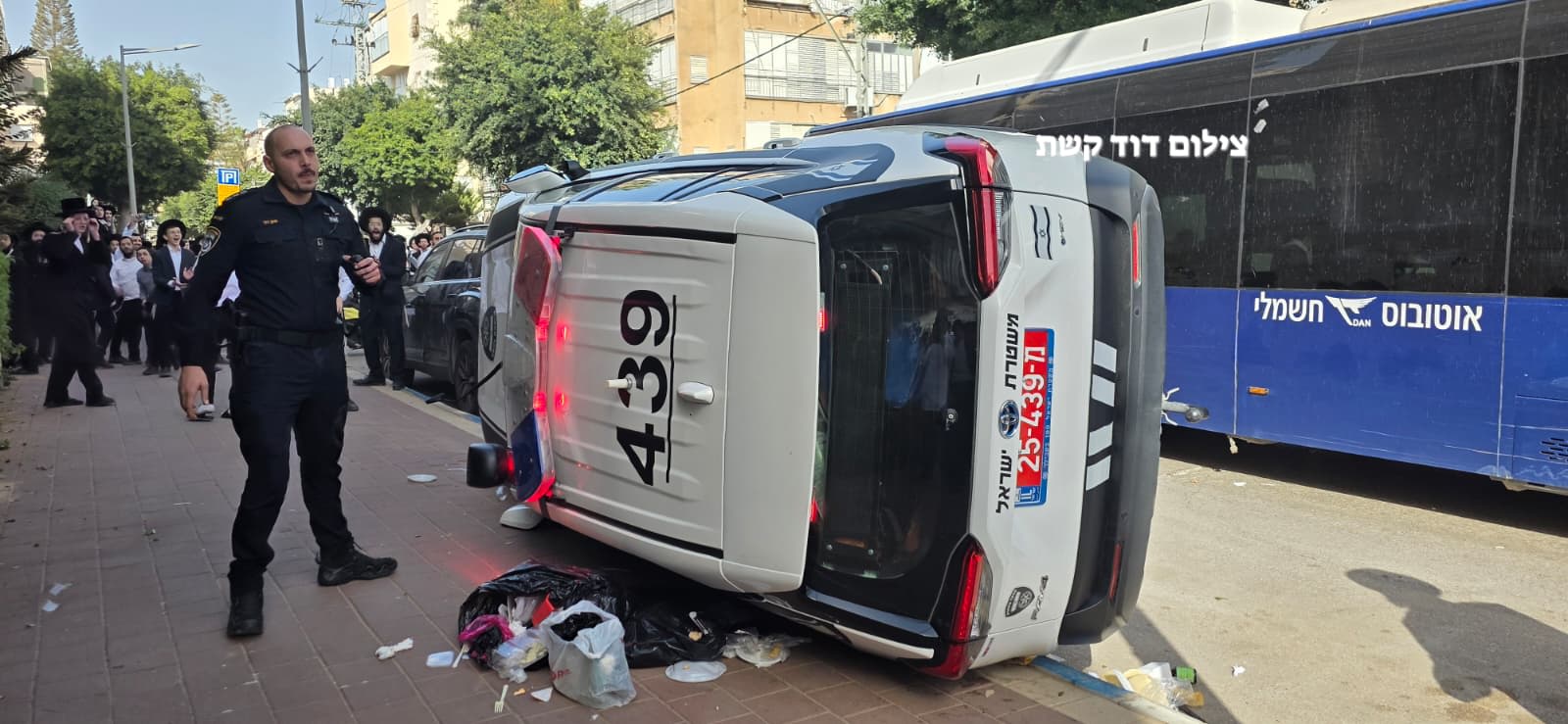 Haredi (ultra-Orthodox) mob flips police car while chasing female soldiers in Bnei Brak, February 15, 2026. (photo credit: David Keshet/Yediot Bnei Brak)