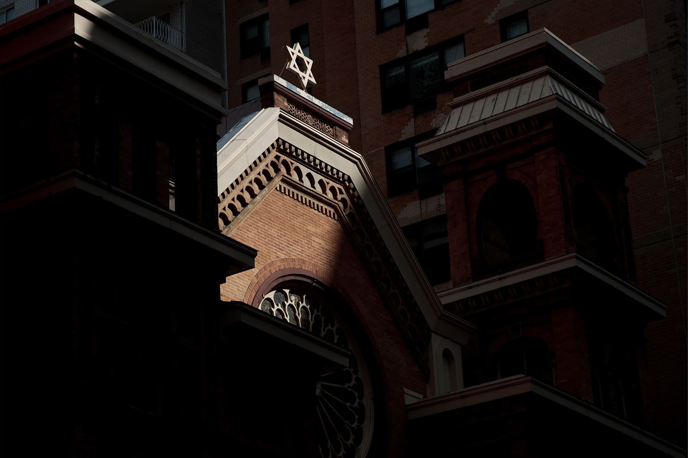 A shaft of light illuminates the Star of David atop the Park East Synagogue in New York City. American Jewry knows what this country that gave it refuge stands for: Democracy, religious liberty, and freedom, the writer maintains.  (photo credit: DREW ANGERER/GETTY IMAGES)