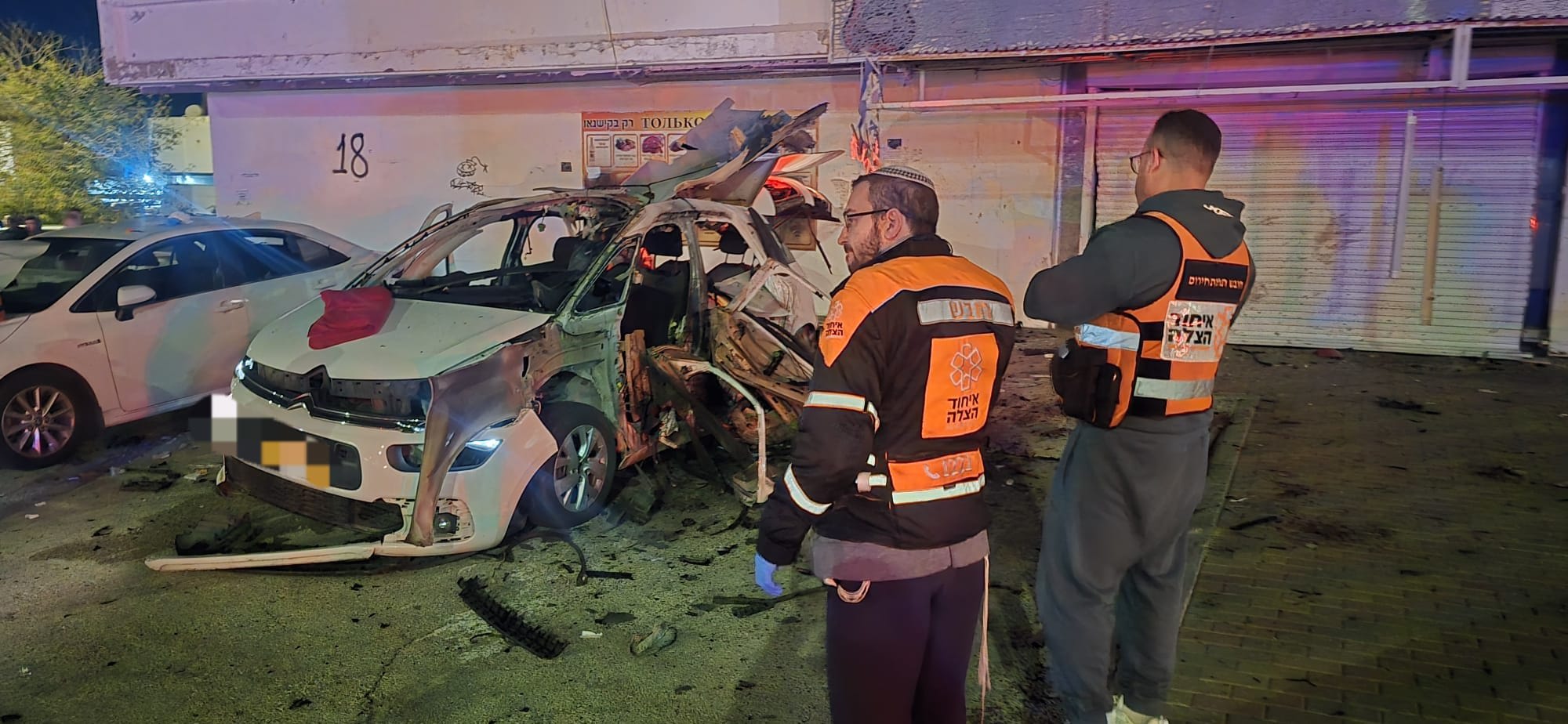 United Hatzalah emergency responders look on in the aftermath of a vehicle explosion in Kiryat Yam, near Haifa, February 4, 2026. (photo credit: UNITED HATZALAH‏)