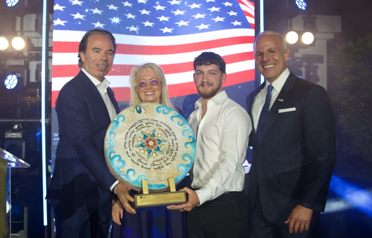 IAC Chairman Emeritus Shawn Evenhaim presents the Defender of Am Yisrael Lifetime Achievement Award to Dr. Miriam Adelson, alongside former hostage Bar Kuperstein and IAC CEO Elan S. Carr. (photo credit: NOAM TEMES)