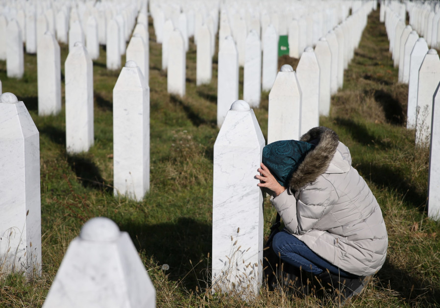 A woman reacts near a grave of her family members in the Memorial centre Potocari near Srebrenica, Bosnia and Herzegovina, after the court proceedings of former Bosnian Serb general Ratko Mladic, November 22, 2017.