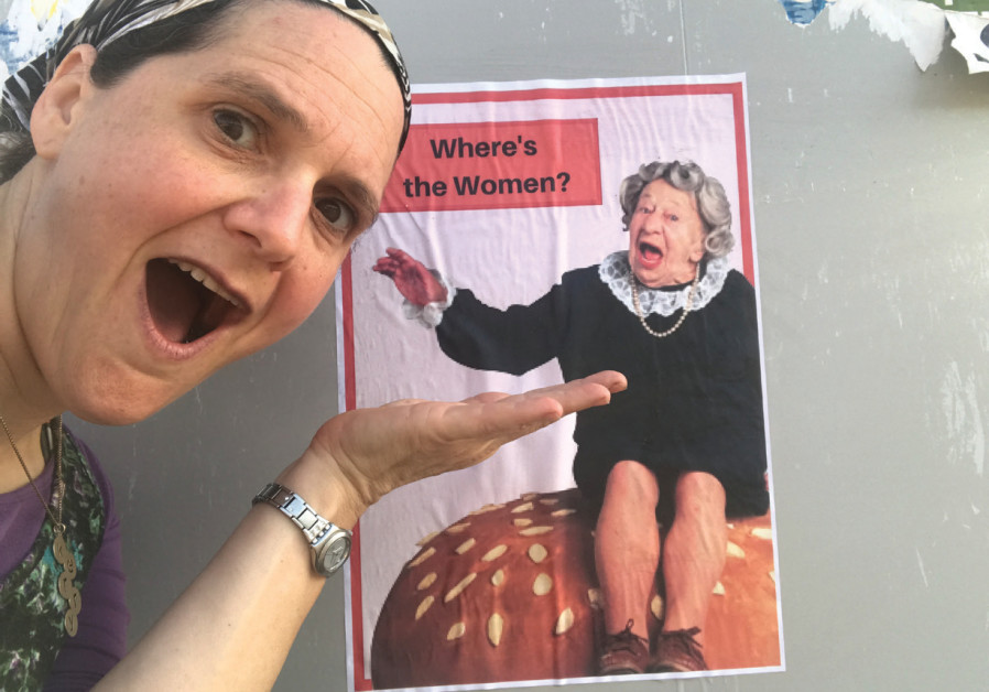 Kerry Bar-Cohn in front of a poster from her campaign to bring back posters featuring women to the streets fo Ramat Beit Shemesh 