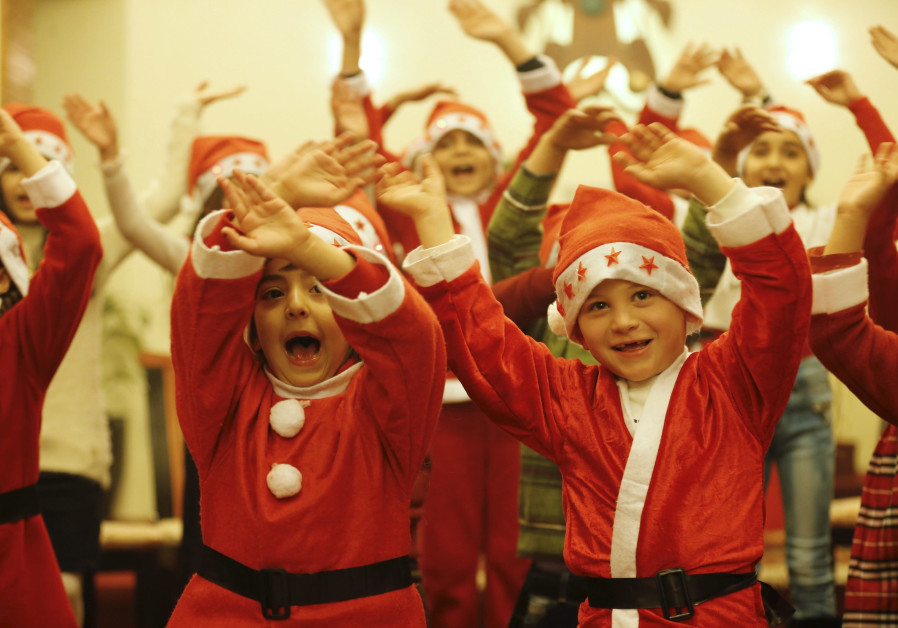 Iraqi children celebrate Christmas at the Church of the Sacred Heart in Baghdad (Credit: Thaier Al-Sudani/ Reuters)