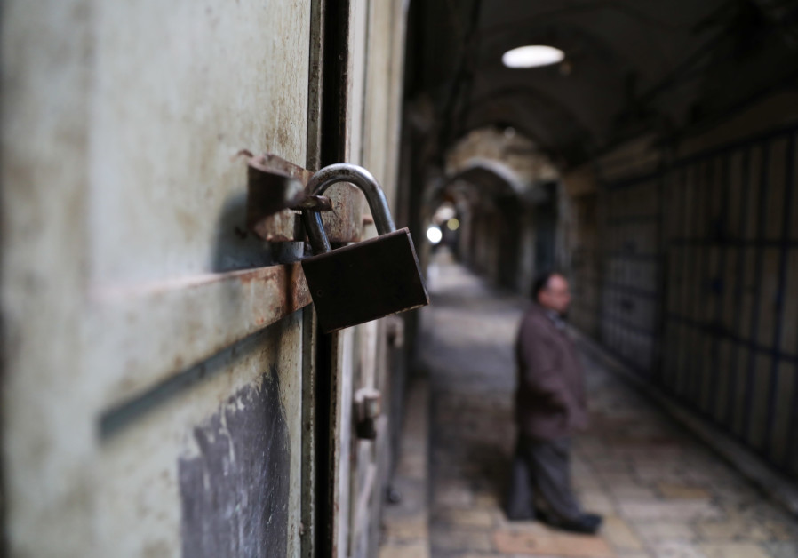  A lock is seen on a closed shop in the Old City of Jerusalem as part of the general Palestinan strike against US VP Pence's visit, January 2018 (credit: Ammar Awad/ Reuters)