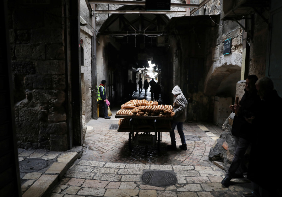 A man sells bread in the nearly-empty Muslim quarter of Jerusalem's Old City during the Palestinian's general strike against US VP Pence's visit,  (Credit: Ammar Awad/ Reuters)