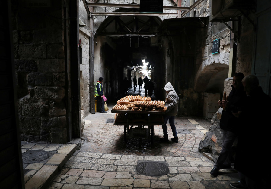 A street vendor selling baked goods stands in a street in which closed shops can be seen, as Palestinian political parties call for a general strike protesting the visit of U.S. Vice President Mike Pence in Jerusalem and the U.S. recognition of Jerusalem as Israel's capital, in Jerusalem's Old City Ammar Awad/ Reuters