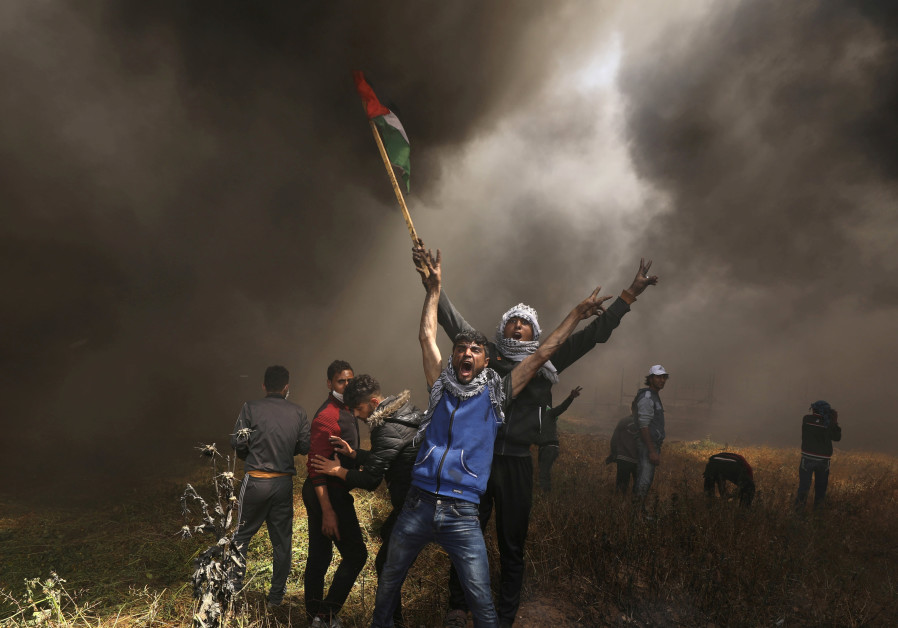 Palestinians burn tires during Gaza protests (Mohammed Salem/ Reuters)