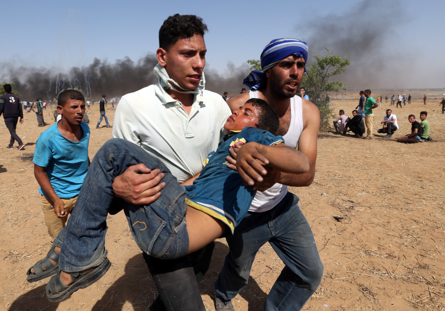 A wounded Palestinian boy is evacuated during a protest marking al-Quds Day, (Jerusalem Day), at the Israel-Gaza border in the southern Gaza Strip June 8, 2018. IBRAHEEM ABU MUSTAFA / REUTERS 