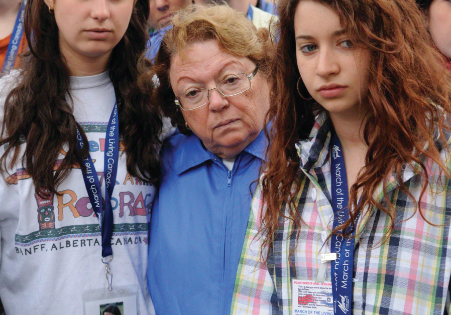 ANITA EKSTEIN stands between two students at the March of the Living  / Courtesy