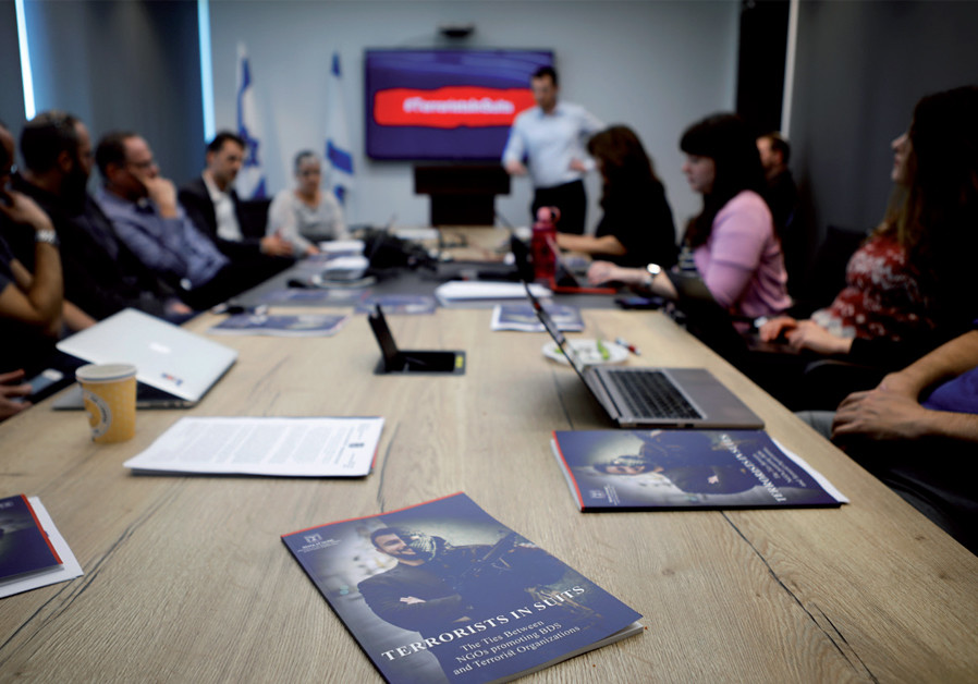 Israel’s Ministry of Strategic Affairs briefs reporters in Bnei Brak on February 3 on its new report revealing ties between terrorist groups and NGOs that support the BDS movement (Credit: Nir Elias/Reuters)
