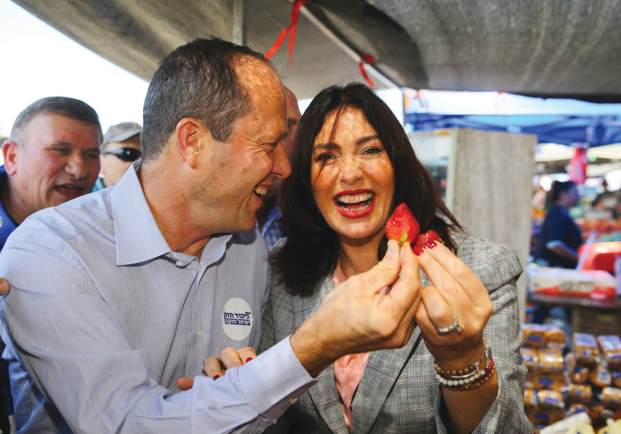 USING EACH other? Barkat and Miri Regev marvel over fruit as they tour an Ashdod market in April 2019. (Flash90) 