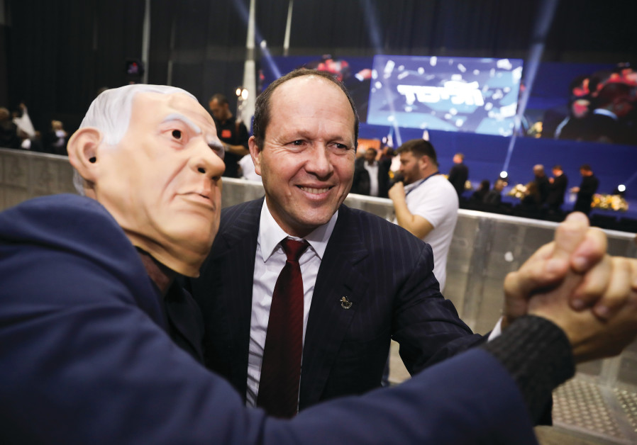 BARKAT TAKES an election-night photo with a Bibi-masked man at Likud Party headquarters in Tel Aviv on March 2. (Olivier Fitoussi/Flash90)