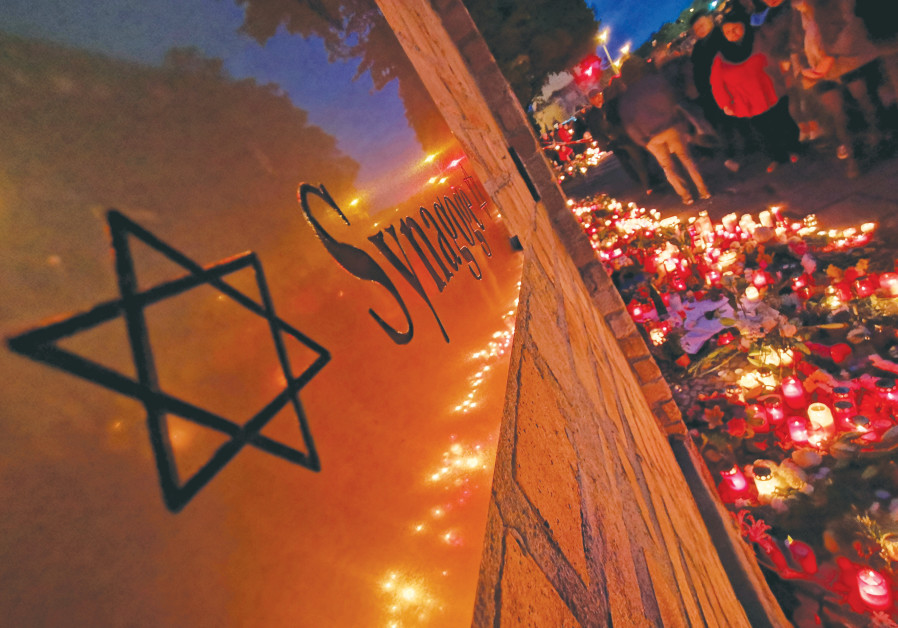 CANDLES LIGHT the scene of the fatal shooting outside a synagogue in Halle, Germany, in October 2019.  (Hannibal Hanschke/Reuters)