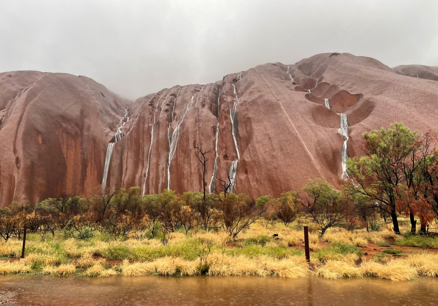 Waterfalls tumble over the surface of Uluru in the Northern Territory, Australia, March 21, 2021, in this picture obtained from social media./ STACEY MACGREGOR/REUTERS