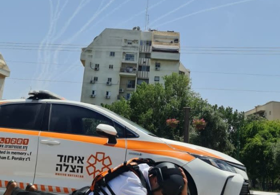 Dov Maisel taking cover from a rocket attack in Ashkelon ( Photo credit: United Hatzalah )