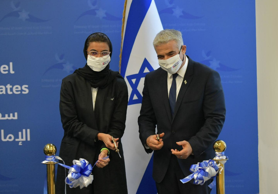 Foreign Minister Yair Lapid cutting the ribbon to the Israeli Embassy in Abu Dhabi with Emirati Culture and Youth Minister Noura Al Kaabi, June 29, 2021. (Credit SHLOMI AMSALEM/GPO)