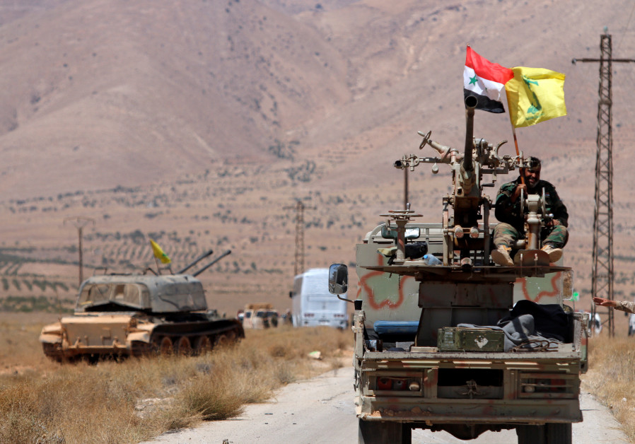 Hezbollah and Syrian flags flutter on a military vehicle in Western Qalamoun, Syria August 28, 2017.