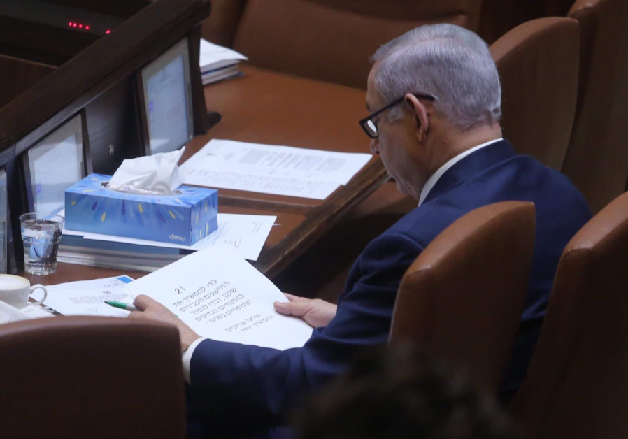 Prime Minister Benjamin Netanyahu reads from his speech in the Knesset on March 12, 2018 
