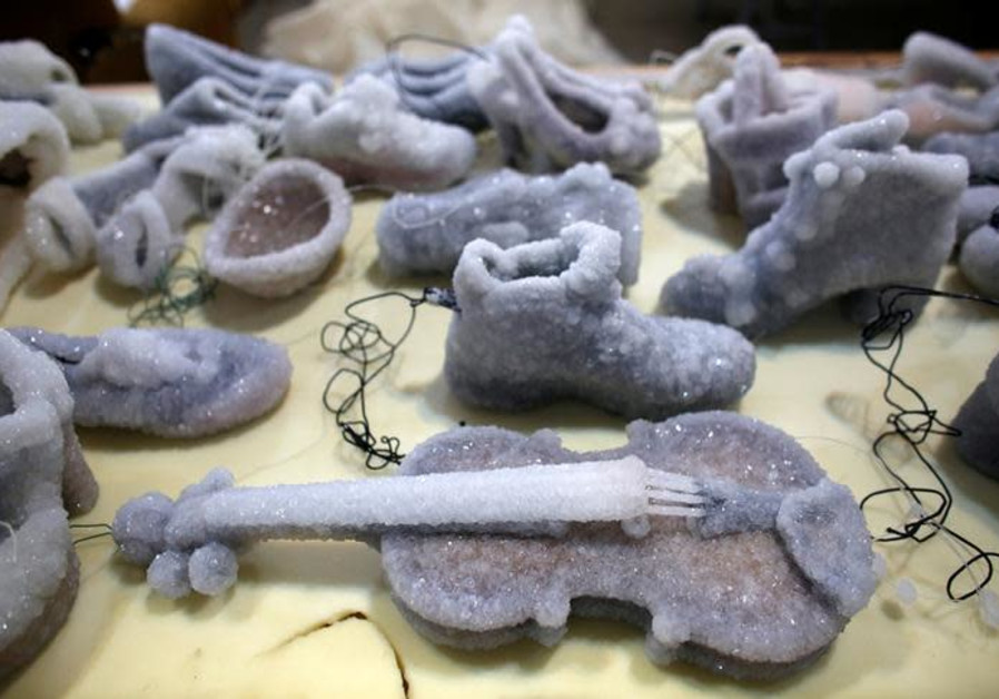 Israeli artist Sigalist Landau's pieces, objects covered in salt crystal formations after they were removed from the hyper-saline waters of the Dead Sea, are displayed at her studio in Kibbutz Almog, Israel (NIR ELIAS/REUTERS)