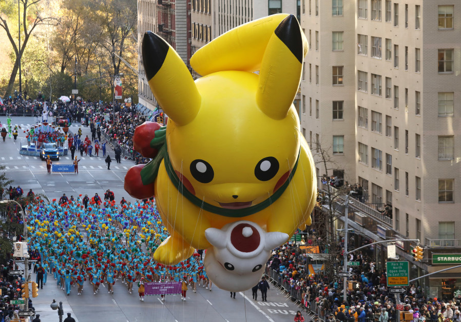 The Pikachu balloon make its way down 6th Ave during the 91st Macy's Thanksgiving Day Parade in the 